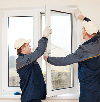 Two workers replacing a window