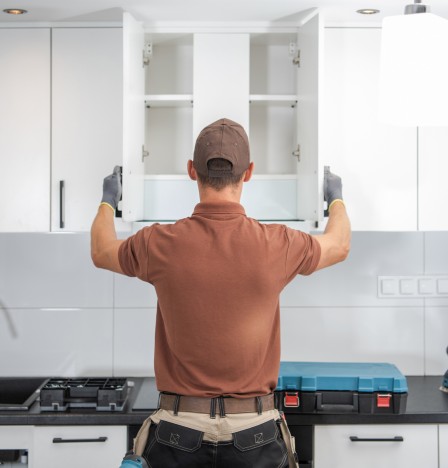 Two workers replacing a window