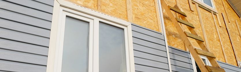 New siding being installed on a house